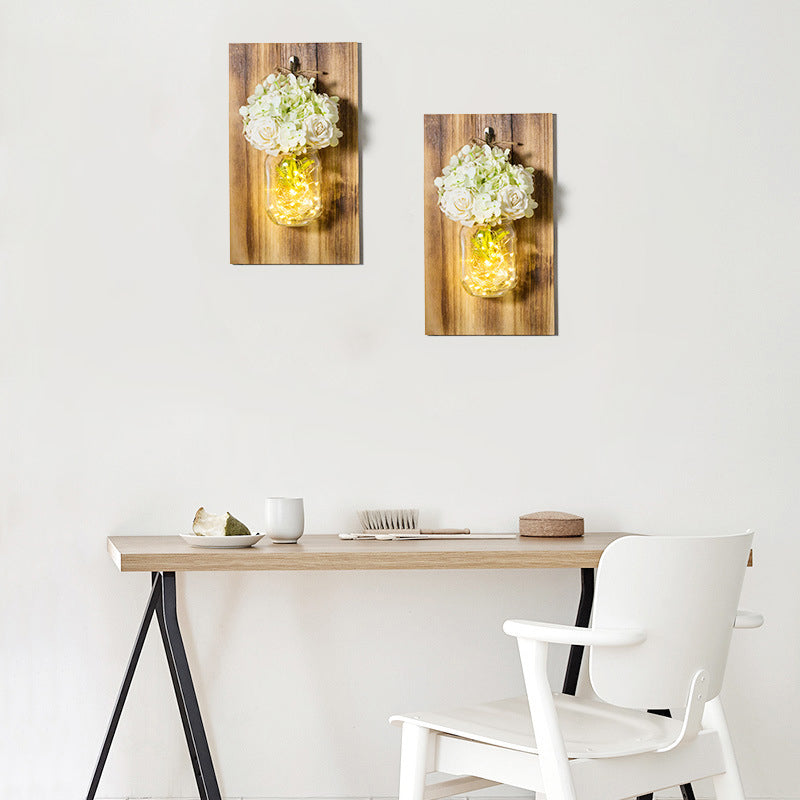 Rynx | Modern white rose string lamp with clear glass container and wooden back panel
