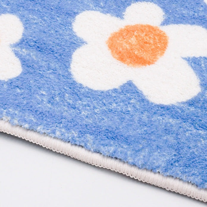 Rynx | White flowers on blue background bath mat