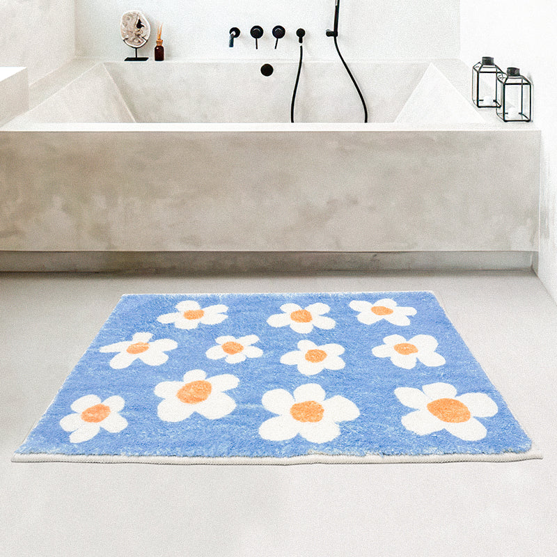 Rynx | White flowers on blue background bath mat