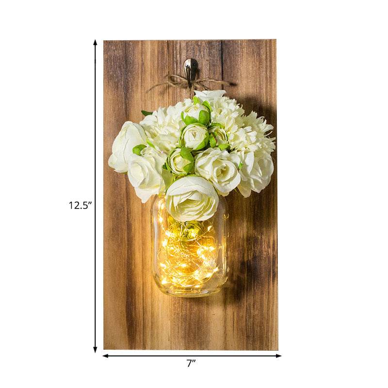Rynx | Modern white rose string lamp with clear glass container and wooden back panel