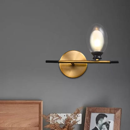 Rynx | Brass straight bar wall light Mid Century 1 head metal wall light ideas with dual oval clear/amber glass shade