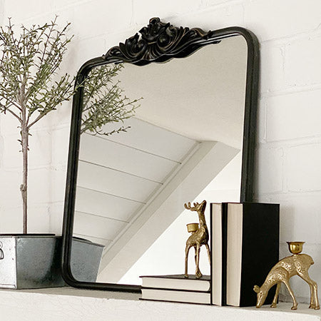 Rynx | Ornate black mirror with carved border