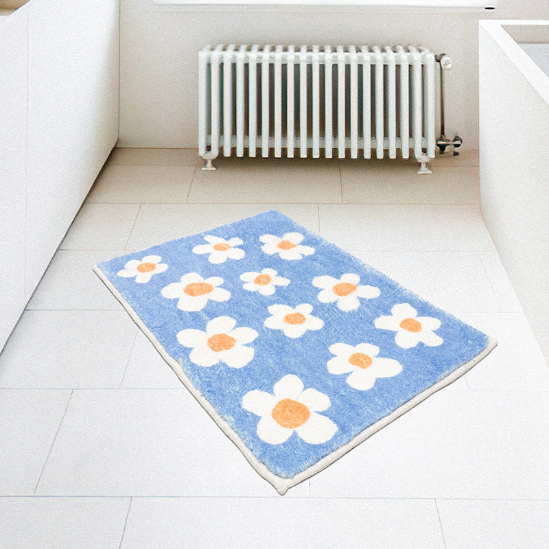 Rynx | White flowers on blue background bath mat
