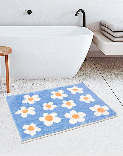 Rynx | White flowers on blue background bath mat