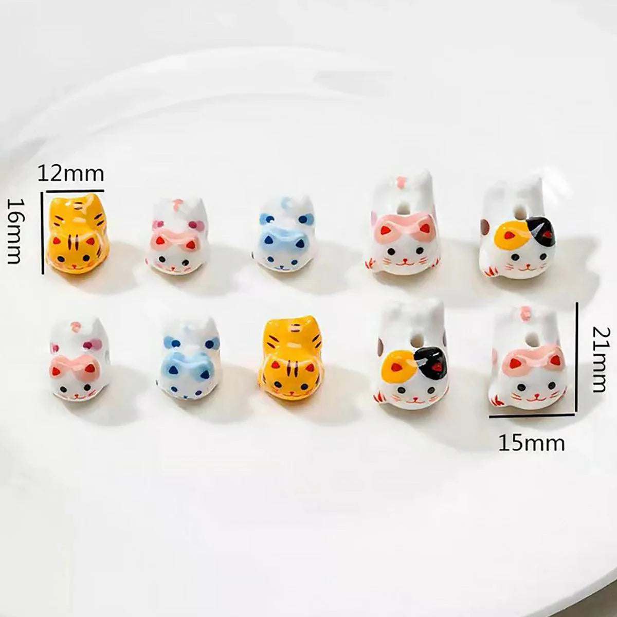 Rynx | Charming anime-inspired lucky cat ceramic beads for creative jewelry projects - 15x21mm porcelain essentials with vertical hole