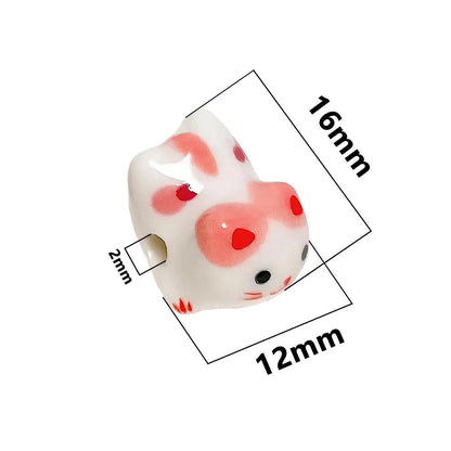 Rynx | Charming anime-inspired lucky cat ceramic beads for creative jewelry projects - 15x21mm porcelain essentials with vertical hole